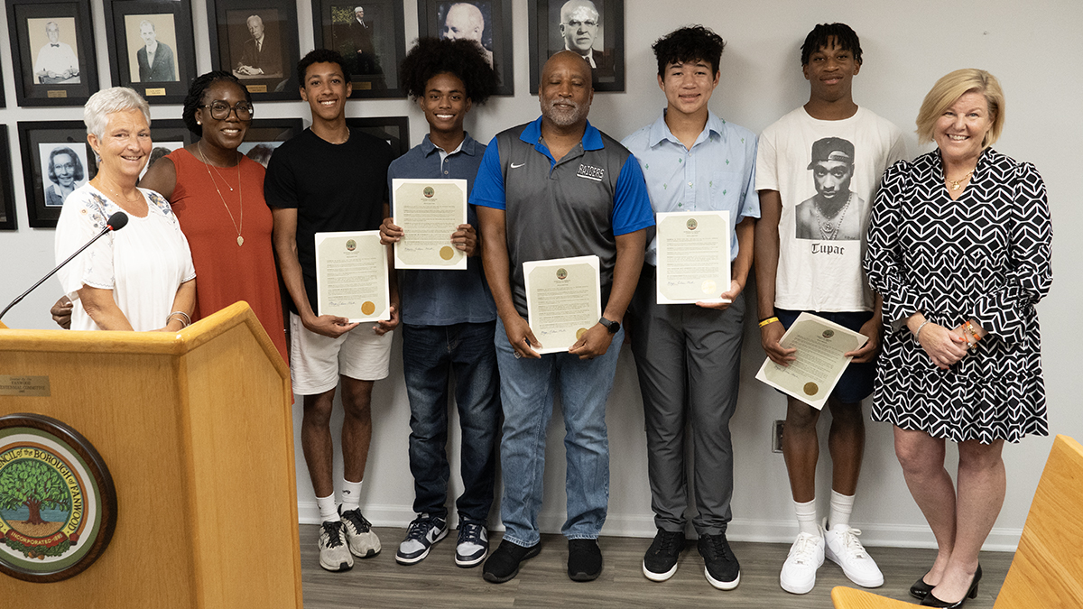 Boys’ Track. Left to right: Councilwomen Patricia Walsh and Gina Berry, Nate Rayan, Ameen Zubair, Coach Rich McGriff, Justice Larkin, Ian Hopkins and Mayor Colleen Mahr